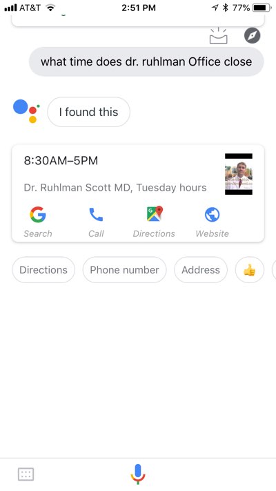 Google Assistant app on iPhone with the results of a “what time does dr. ruhlman office close” query. The results displayed include a card with “8:30AM–5:00PM” and the label, “Dr. Ruhlman Scott MD, Tuesday hours,” as well as links to call the office, search on Google, get directions, and visit a website. Additionally, there are four buttons labeled with the words “directions,” “phone number,” and “address,” and a thumbs-up emoji.